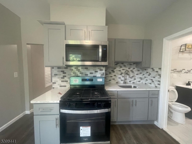 160 12th Avenue, Unit 2 Paterson, NJ 07501 - Photo 1 of 17 a kitchen with a stove and a sink