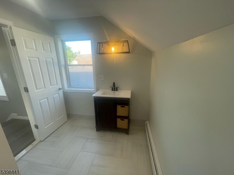 160 12th Avenue, Unit 2 Paterson, NJ 07501 - Photo 11 of 17 a bathroom with a sink a toilet and a mirror