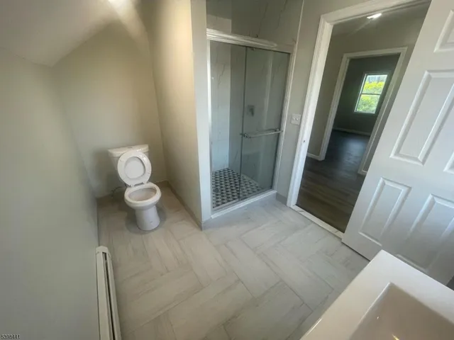 a view of a bathroom with toilet and a shower