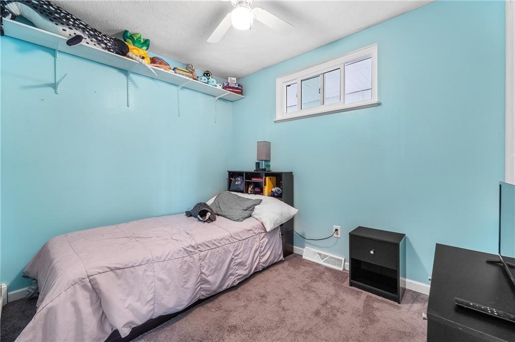 604 Lincoln Street Rochester, PA 15074 - Photo 12 of 23 a bedroom with a bed and a tv