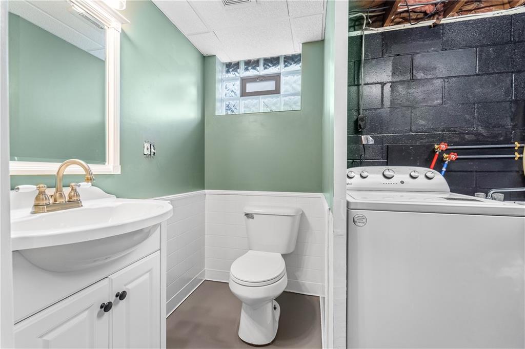 604 Lincoln Street Rochester, PA 15074 - Photo 19 of 23 a bathroom with a toilet sink and mirror