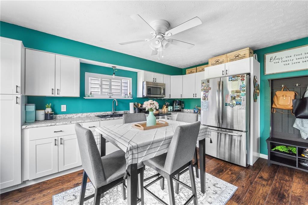 604 Lincoln Street Rochester, PA 15074 - Photo 6 of 23 a kitchen with stainless steel appliances granite countertop a refrigerator a microwave oven a sink dishwasher and a refrigerator with wooden floor