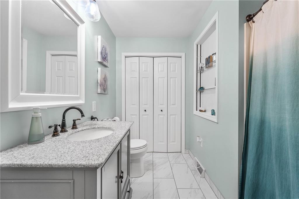 604 Lincoln Street Rochester, PA 15074 - Photo 7 of 23 a bathroom with a granite countertop sink and a mirror