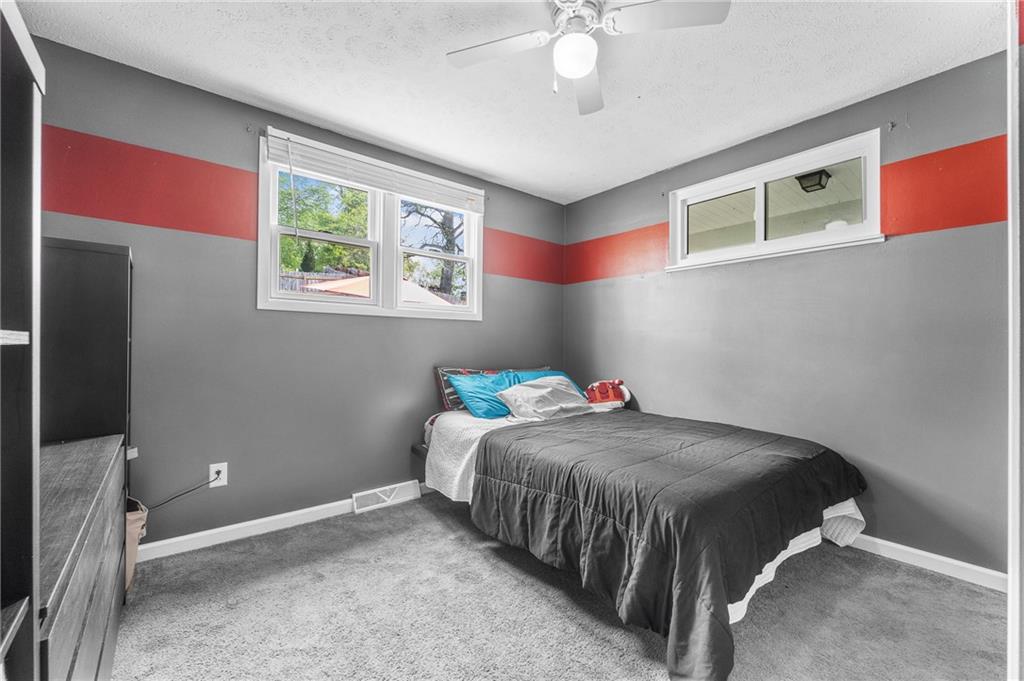 604 Lincoln Street Rochester, PA 15074 - Photo 10 of 23 a bedroom with a bed and a window