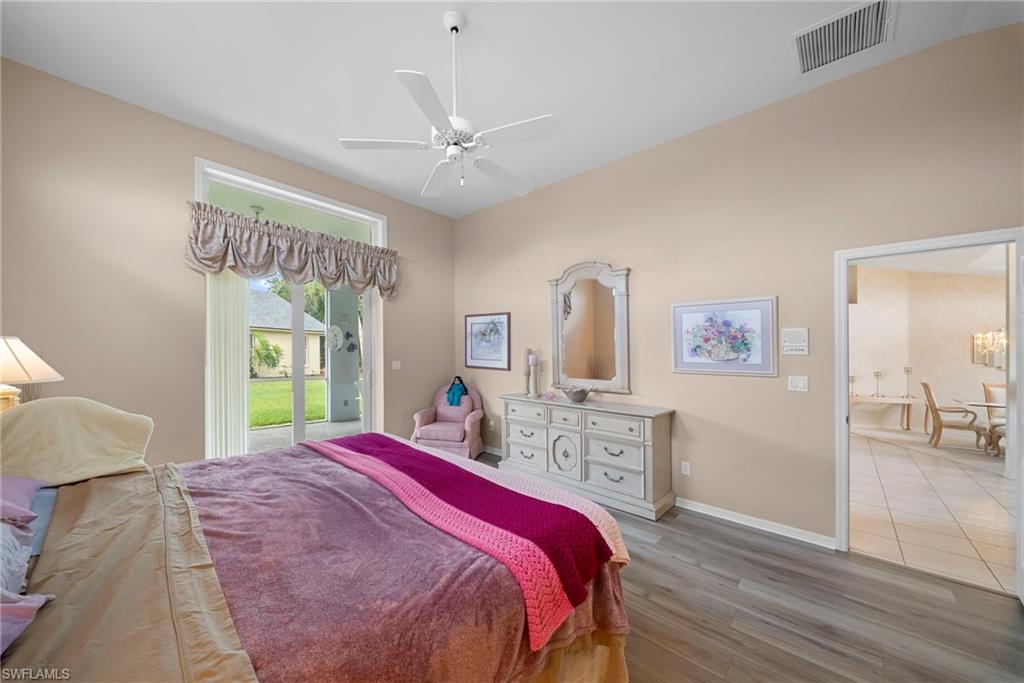 3971 Spring Garden Lane Estero, FL 33928 - Photo 10 of 31 a bed room with a bed and a chandelier