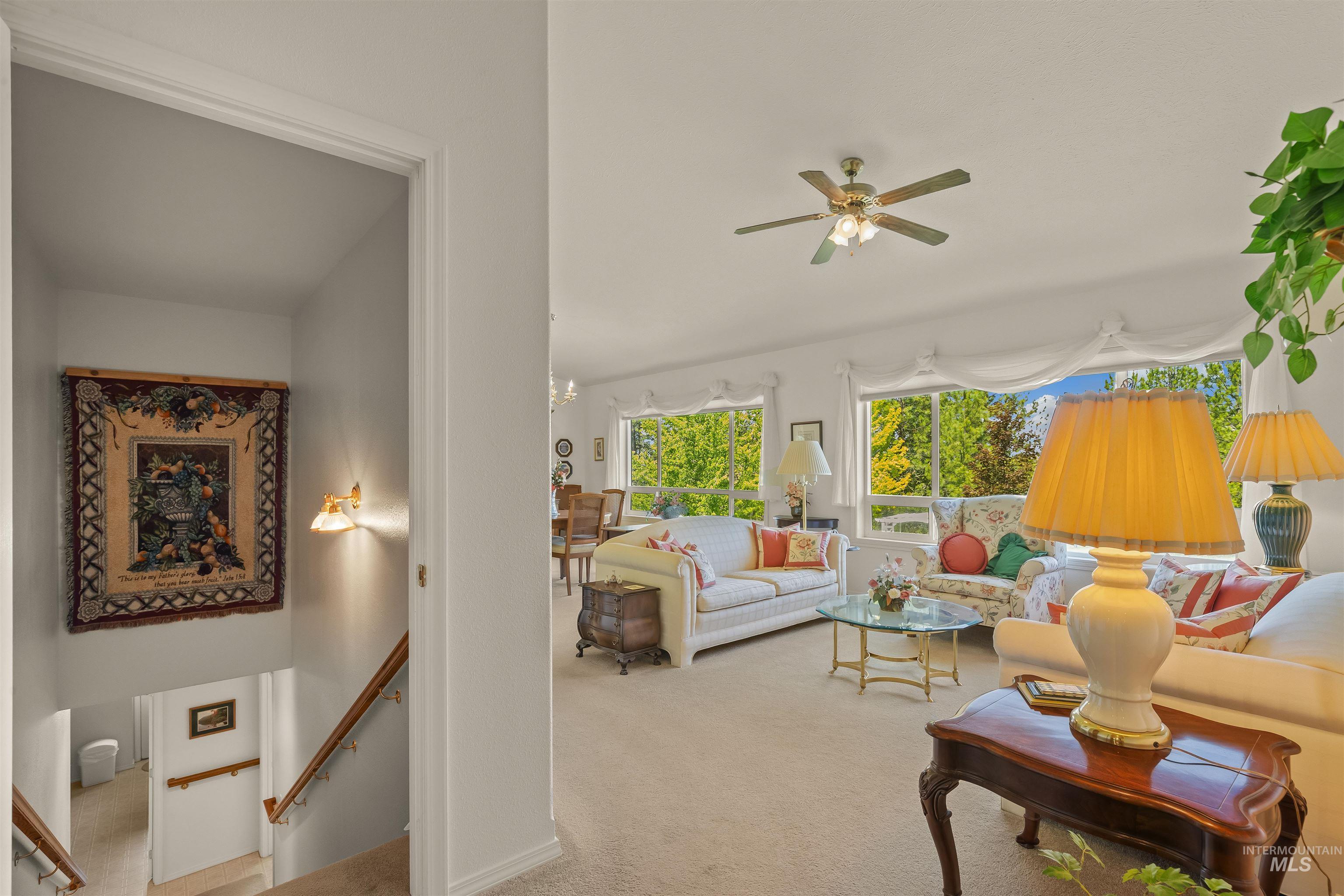 743 Wall Crk Road Stites, ID 83552 - Photo 32 of 48 Bright living space featuring expansive windows, neutral carpeting, and a ceiling fan
