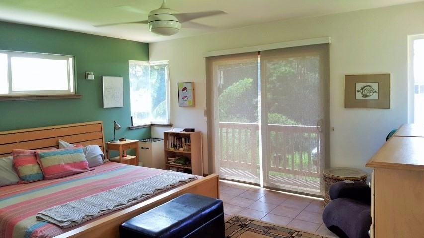 5004 Awawa Road Eleele, HI 96705 - Photo 13 of 21 a bedroom with a bed and wooden floor