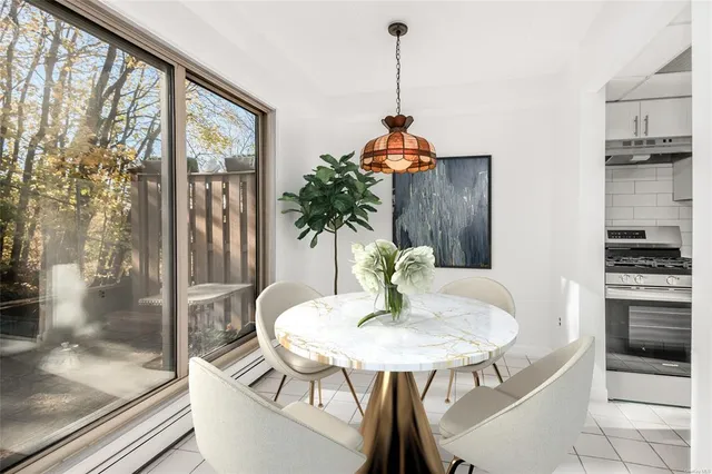 a view of a room with a table and chairs