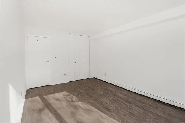 an empty room with wooden floor