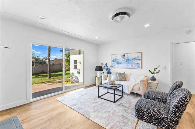a living room with furniture a rug and a table