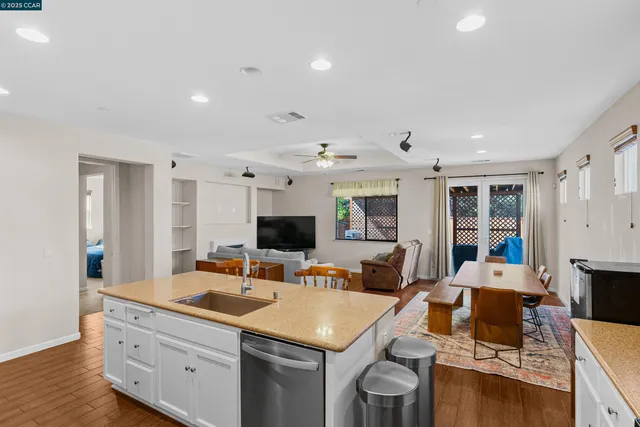a living room with furniture flat screen tv and large window