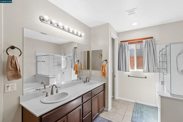 a bathroom with a sink vanity and mirror