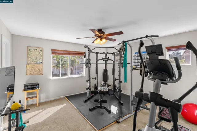 a room with gym equipment and windows