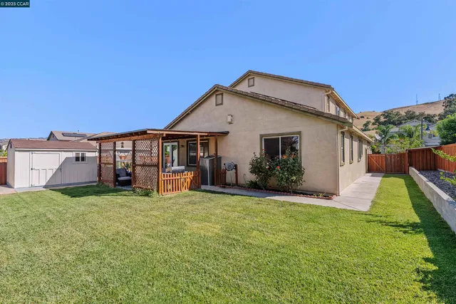 a view of a house with a yard and sitting area