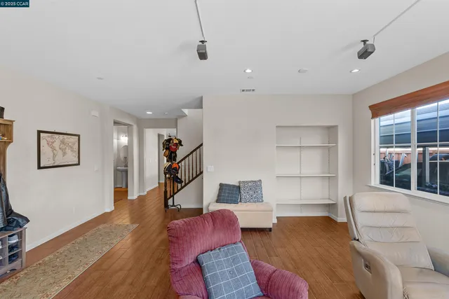 a living room with furniture and a book shelf