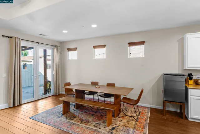 a view of a workspace with furniture and wooden floor