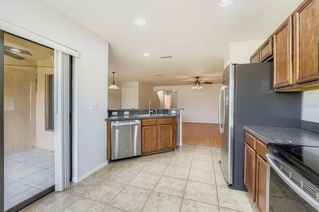a kitchen with a refrigerator stove and cabinets