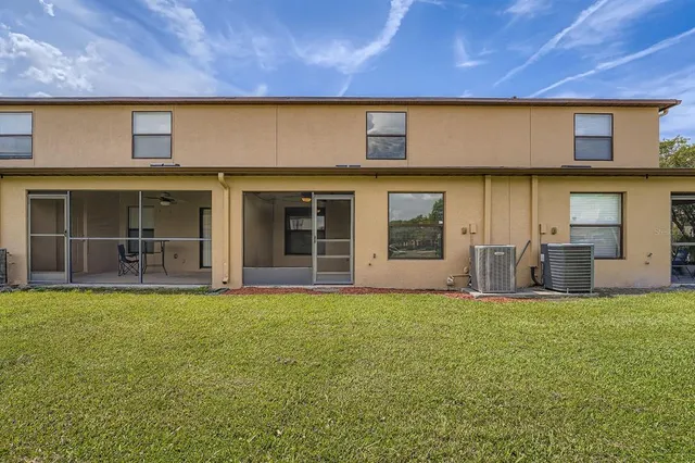 a view of a house with a yard and a large window