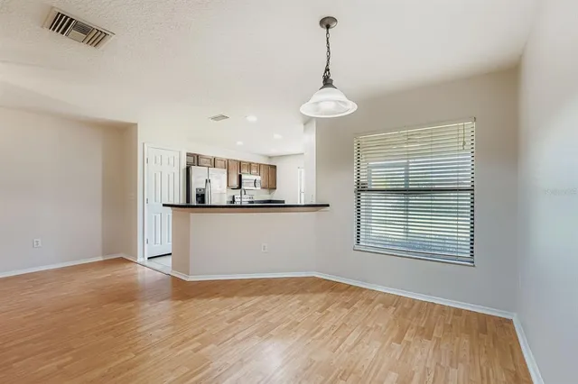 a view of a room with a wooden floor and a window