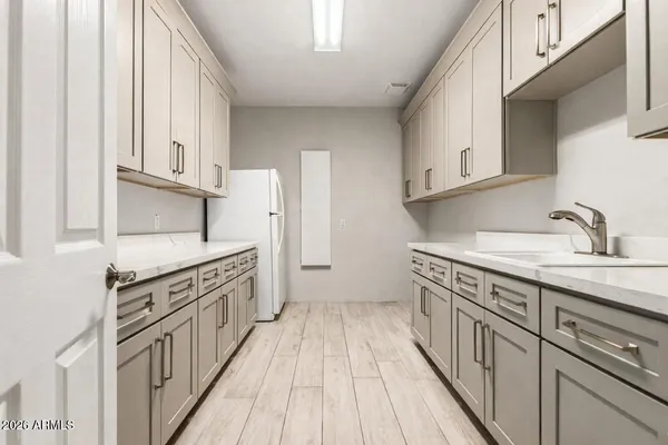 a kitchen with granite countertop a sink and appliances