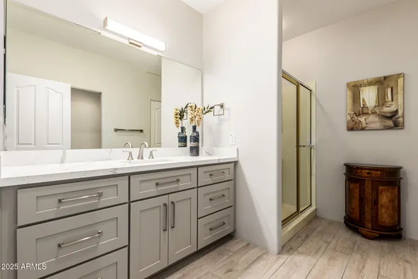a bathroom with a double vanity sink and a mirror