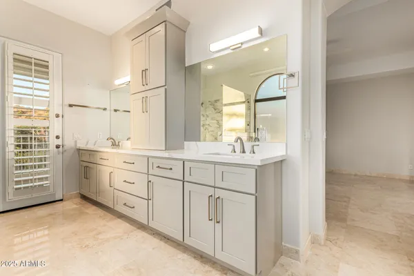 a spacious bathroom with a granite countertop sink mirror and