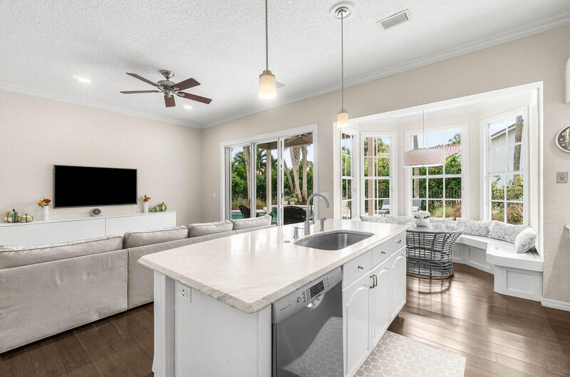 2620 Windham Court Delray Beach, FL 33445 - Photo 14 of 58 a large white kitchen with a large window and stainless steel appliances