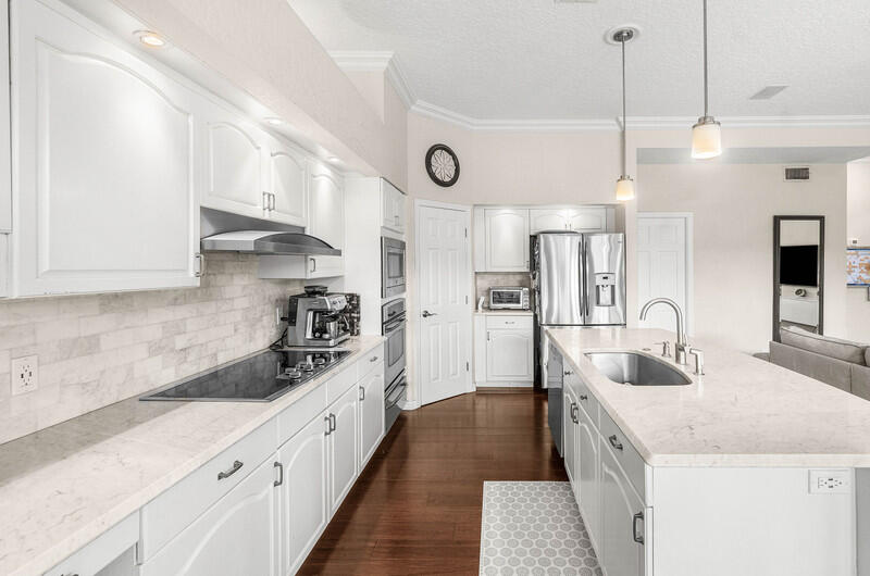2620 Windham Court Delray Beach, FL 33445 - Photo 15 of 58 a kitchen with granite countertop a sink a counter space appliances and cabinets