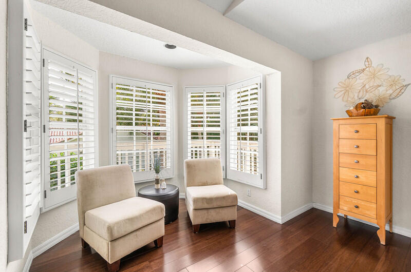 2620 Windham Court Delray Beach, FL 33445 - Photo 24 of 58 a spacious bedroom with a bed and a couch next to a window