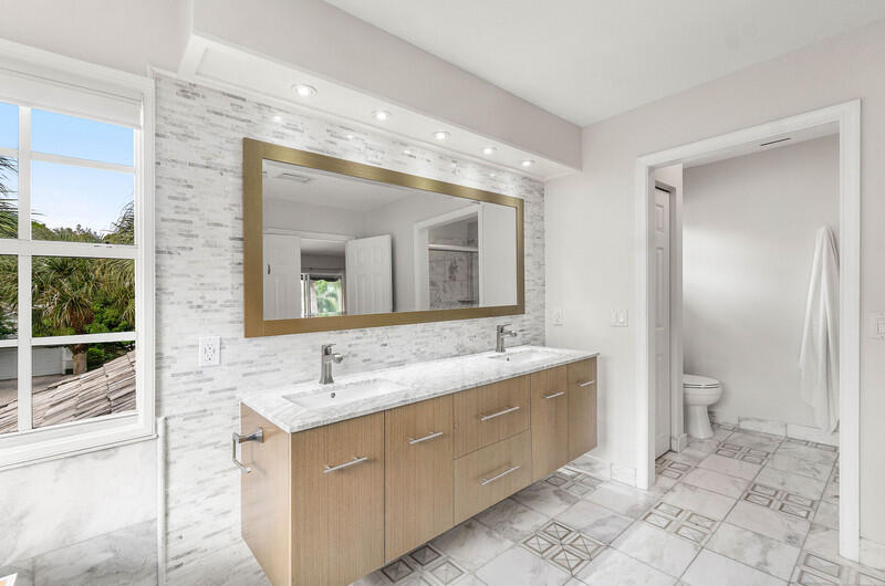 2620 Windham Court Delray Beach, FL 33445 - Photo 26 of 58 a spacious bathroom with a toilet sink and mirror