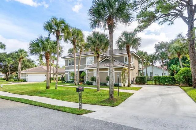 a view of a hallway with wooden floor and a chandelier