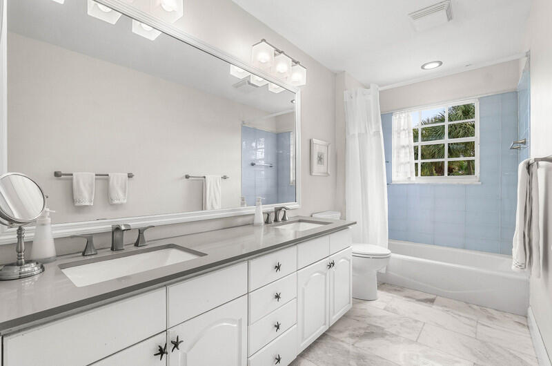 2620 Windham Court Delray Beach, FL 33445 - Photo 32 of 58 a bathroom with double sink and a mirror