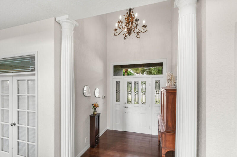 2620 Windham Court Delray Beach, FL 33445 - Photo 4 of 58 a view of a hallway with wooden floor and a chandelier