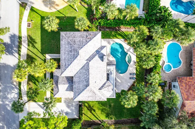 a aerial view of a house with swimming pool and garden
