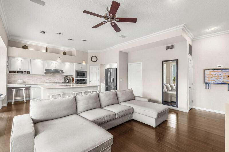 2620 Windham Court Delray Beach, FL 33445 - Photo 10 of 58 a living room with furniture kitchen view and a chandelier