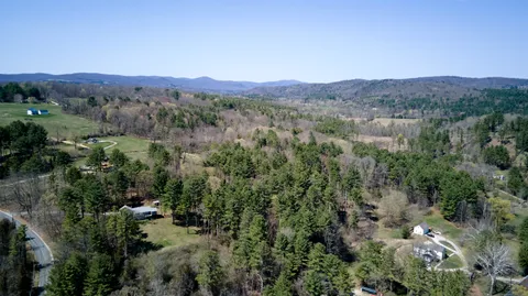 an aerial view of residential house with outdoor space and mountain view