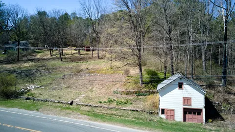 a view of house with backyard and trees