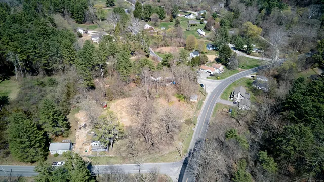 an aerial view of a house with a yard
