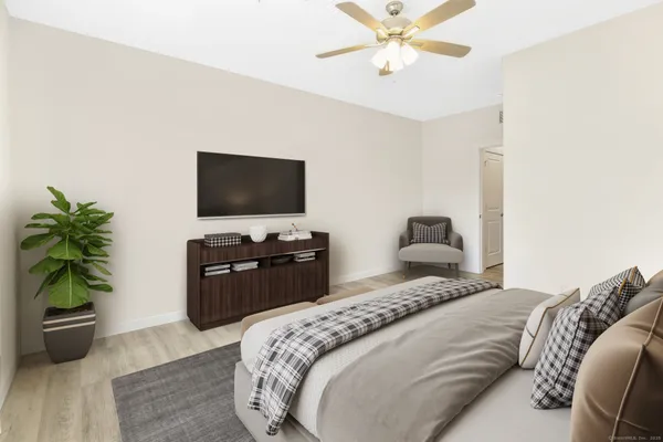 a bedroom with a bed and a flat screen tv