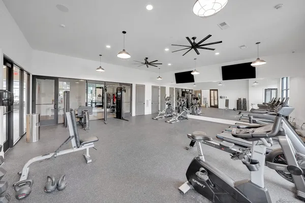 a room with gym equipment and a large window