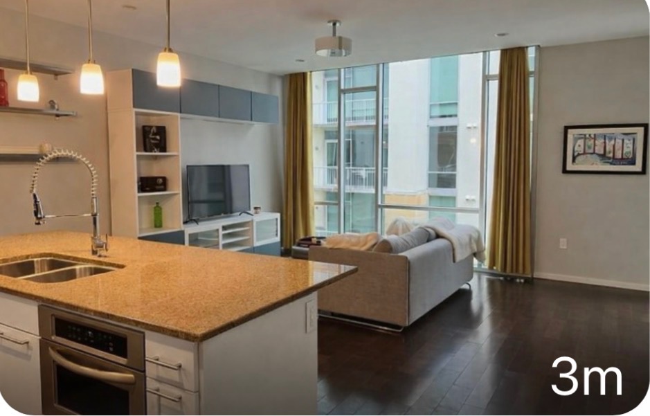 1600 Barton Springs Road, Unit 2302 Austin, TX 78704 - Photo 12 of 12 Kitchen featuring stainless steel oven, open floor plan, dark wood-style flooring, hanging light fixtures, and a kitchen island with sink