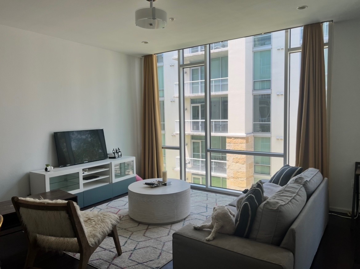 1600 Barton Springs Road, Unit 2302 Austin, TX 78704 - Photo 2 of 12 Living area featuring wood finished floors and floor to ceiling windows