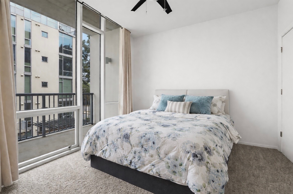 1600 Barton Springs Road, Unit 2302 Austin, TX 78704 - Photo 4 of 12 Bedroom with carpet, expansive windows, access to exterior, and a ceiling fan