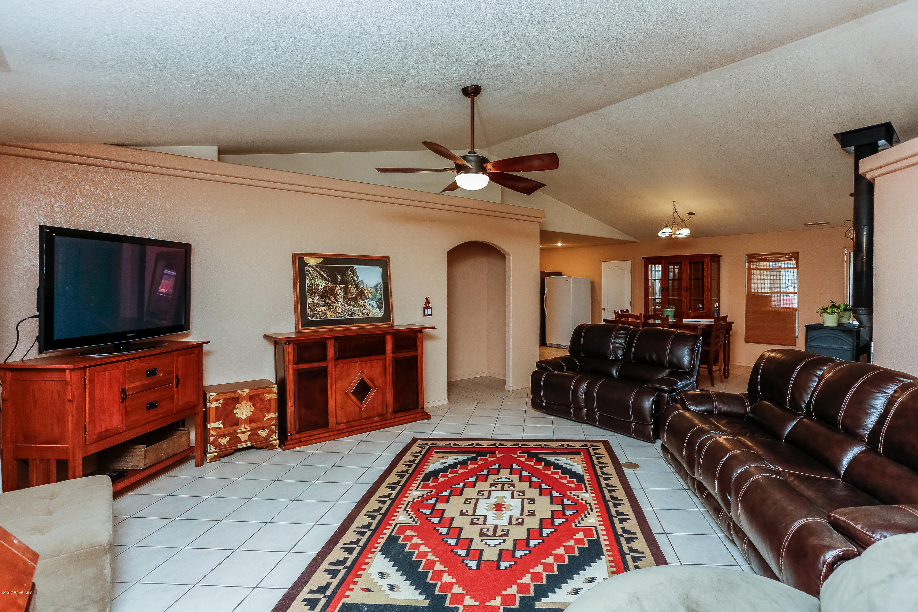 1900 West Big Sky Ranch Road Paulden, AZ 86334 - Photo 4 of 39 a living room with furniture a flat screen tv and a chandelier