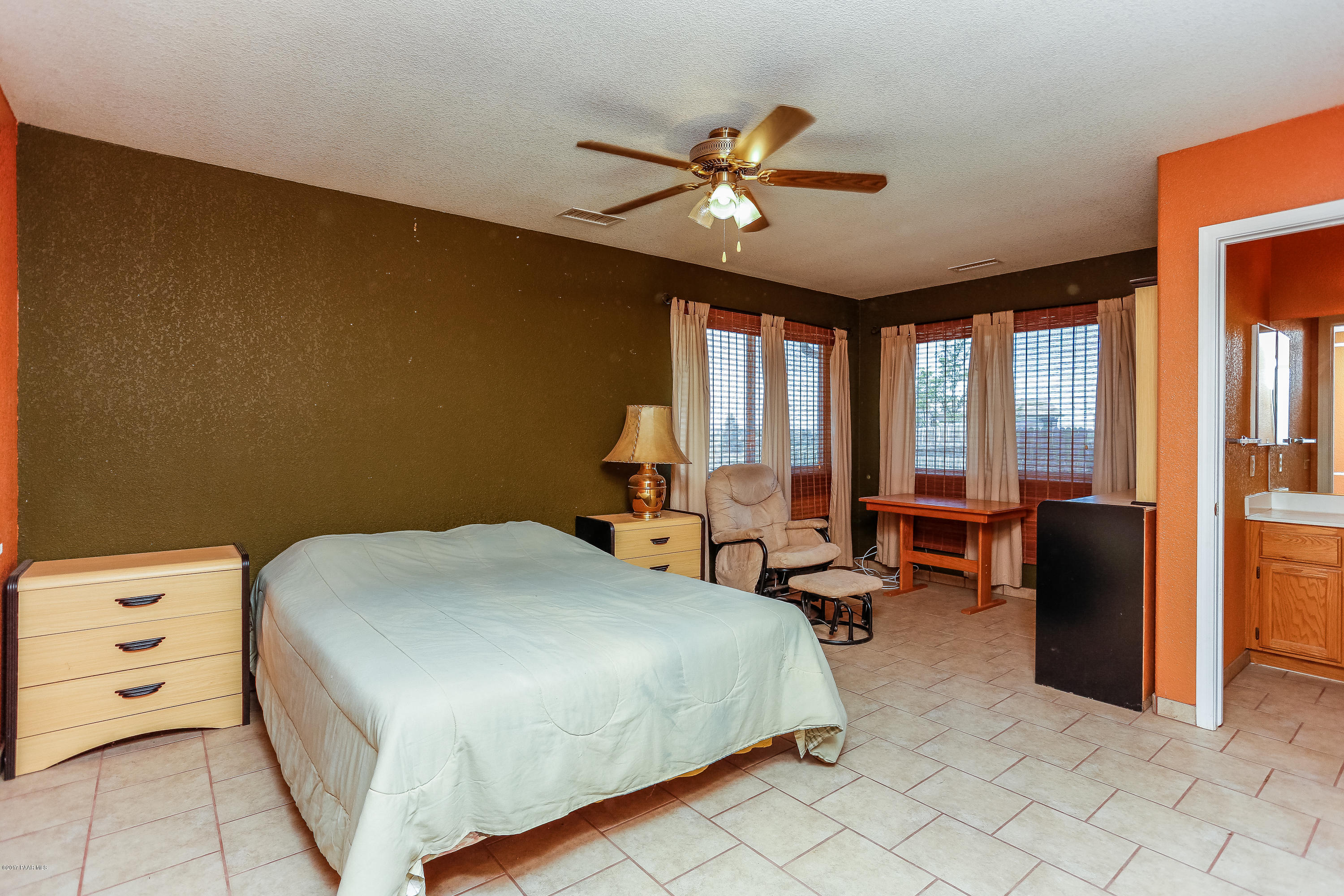 1900 West Big Sky Ranch Road Paulden, AZ 86334 - Photo 7 of 39 a bedroom with a bed and a chandelier