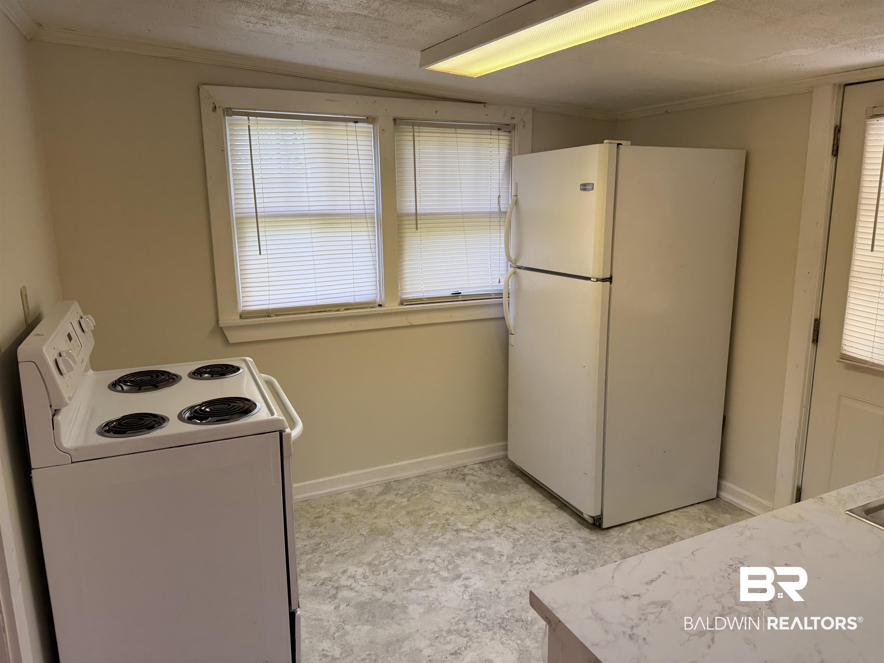 3630 Highway 29 Brewton, AL 36426 - Photo 7 of 13 Kitchen with a textured ceiling and white appliances
