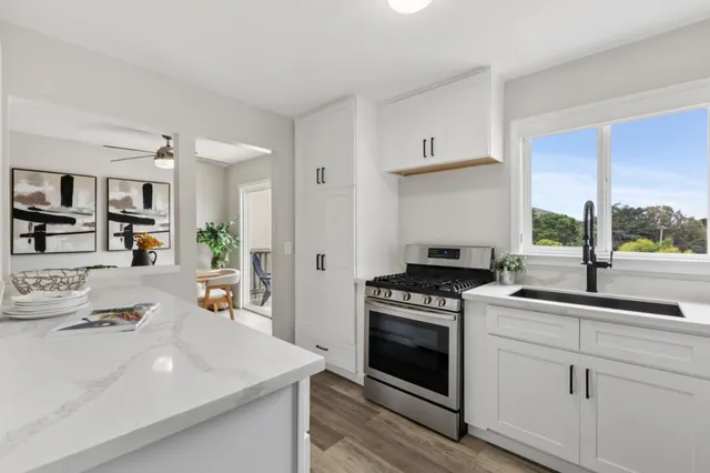 a kitchen with a stove sink and refrigerator