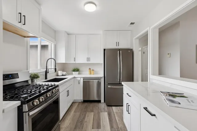 a kitchen with a refrigerator stove and sink