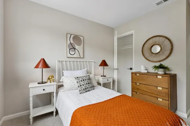 a spacious bathroom with a tub sink and mirror