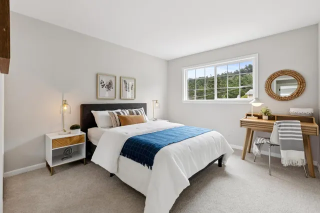 a bedroom with a bed and a table in it